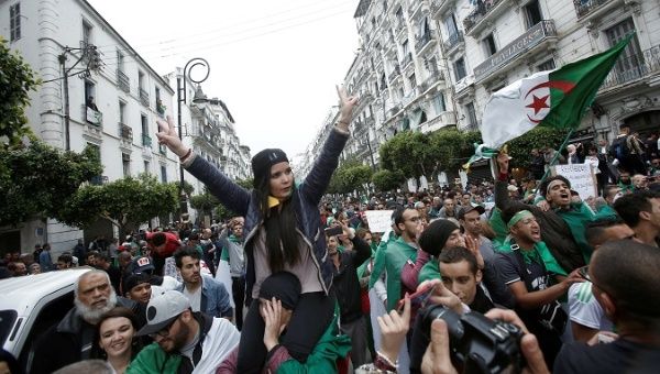 Demonstrators hold flags and banners during peaceful anti-government protests in Algiers, Algeria, May 3, 2019. 