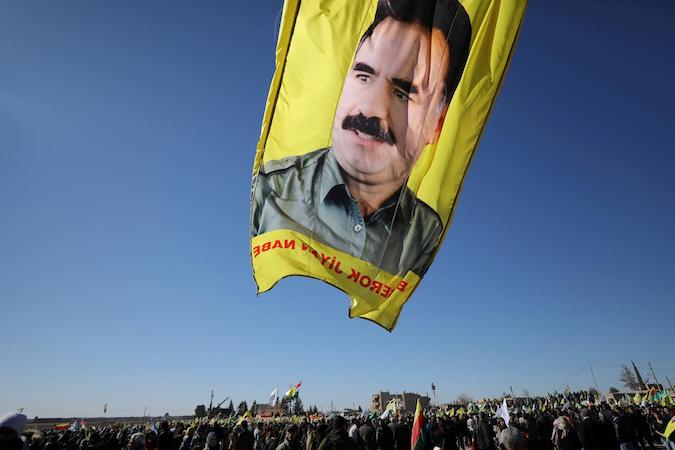 A banner with a picture of imprisoned Kurdish rebel leader Abdullah Ocalan is seen during a protest against the Turkish attacks on Afrin in Qamishli, Syria January 30, 2018.