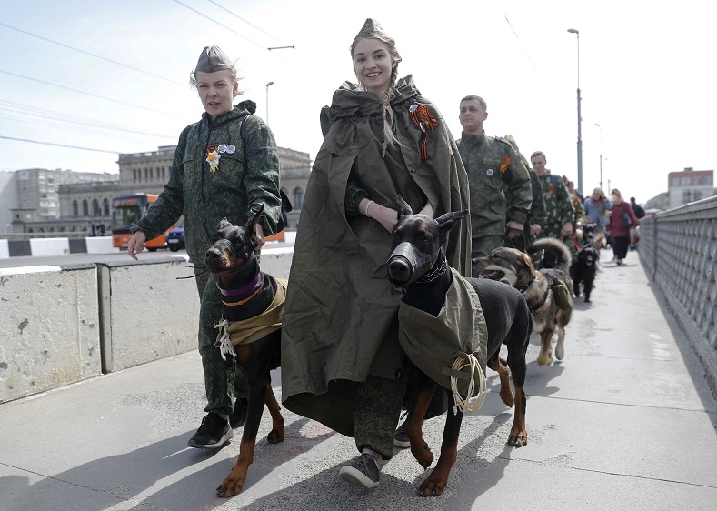 Participants walk during a procession commemorating cynologists and their dogs, who fought against Nazi Germany in World War Two, on the Victory Day in Kaliningrad, Russia.