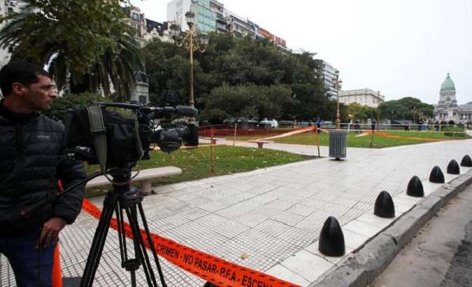 A cameraman works at the crime scene where Argentine Congressman Hector Olivares was injured and his adviser, Miguel Yadon, was killed.