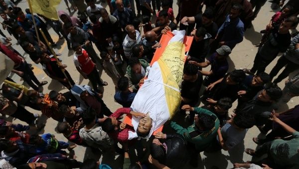 Mourners carry the body of Palestinian man Hani Abu Sha'ar, killed in an Israeli air strike, during his funeral in the southern Gaza Strip.