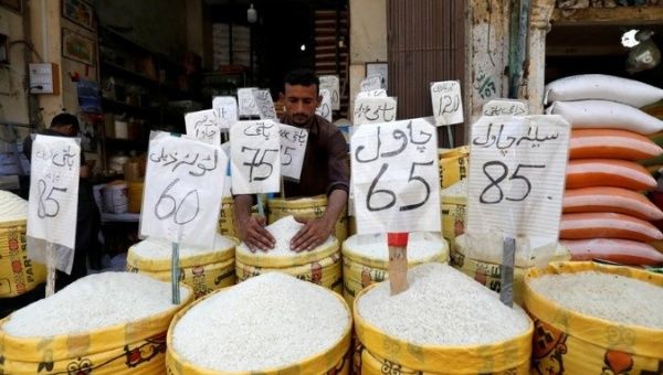 A vendor arranges different types of rice, with their prices displayed, at his shop in a wholesale market in Karachi, Pakistan April 2, 2019