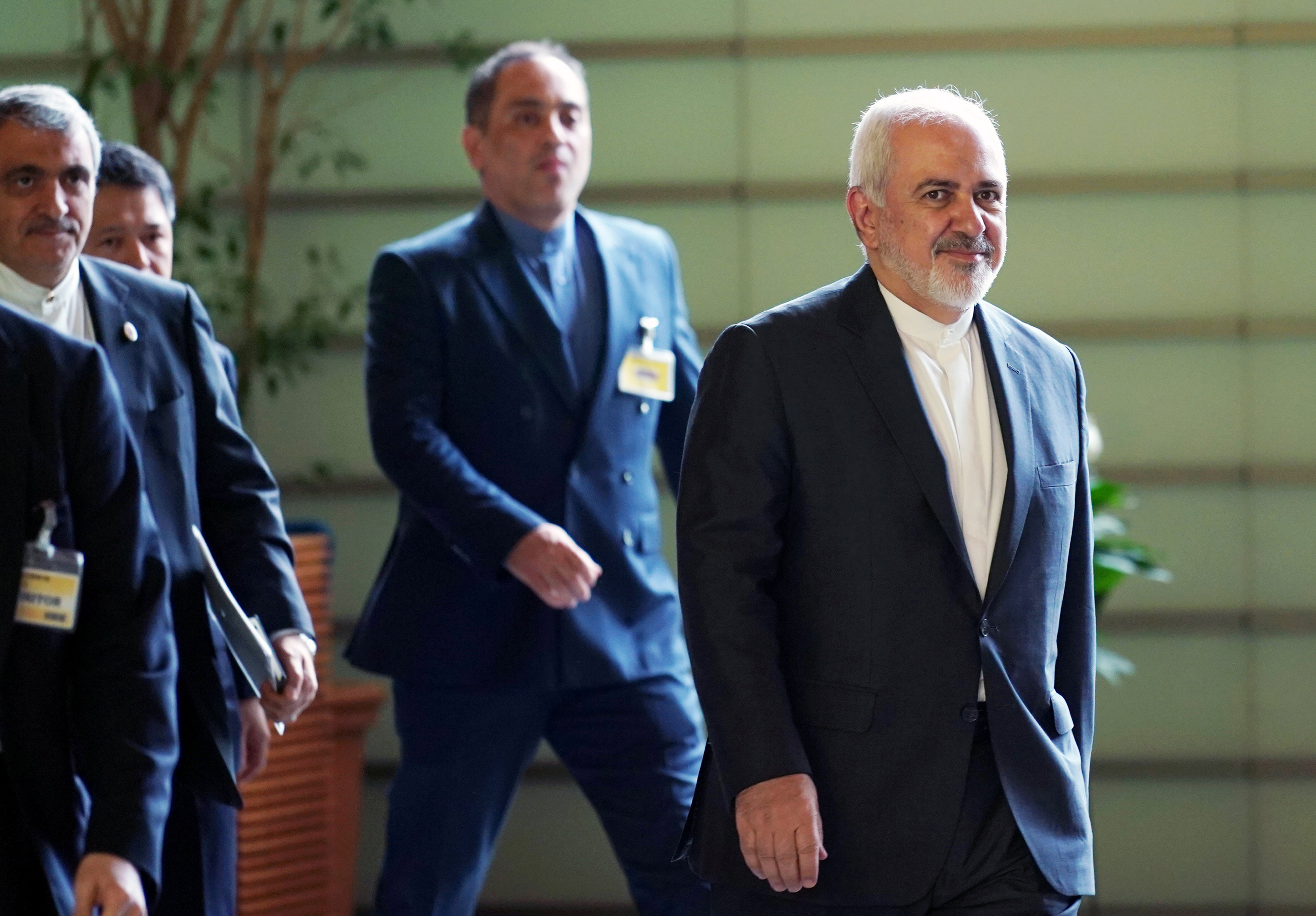 Iranian Foreign Minister Mohammad Javad Zarif, right, walks to meet Japanese Prime Minister Shinzo Abe at Abe's official residence in Tokyo Thursday, May 16, 2019.