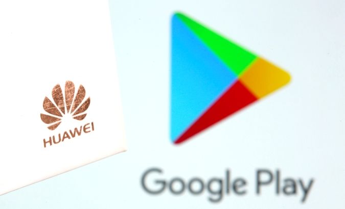 Huawei logo is seen in front of displayed Google Play logo in this illustration taken May 20, 2019.