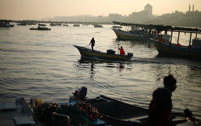 Palestinian fishermen prepare to go out into the Mediterranean