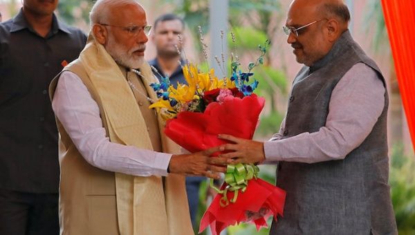 India's Prime Minister Narendra Modi receives a flower bouquet from the Bharatiya Janata Party (BJP) President Amit Shah at the party headquarters in New Delhi, India, May 21, 2019. 