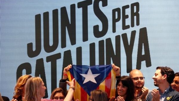 Junts x Catalunya members raise up a Catalan flag as they celebrate the results of the European Parliament elections in Barcelona, Spain