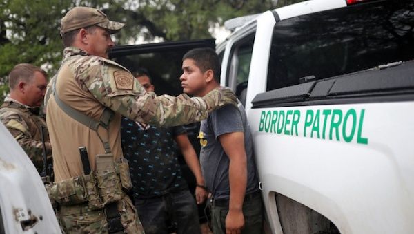Members of the Border Patrol Search, Trauma, and Rescue Unit near Falfurrias, Texas, apprehend an immigrant from Guatemala June 19. 