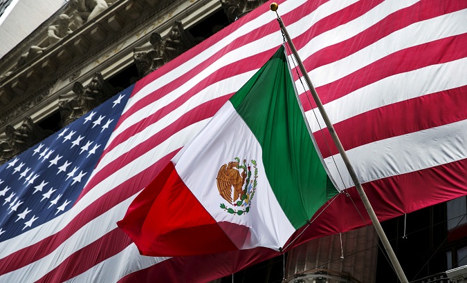 The flag of Mexico changes in front of a large U.S. flag in front of the New York Stock Exchange September 4, 2015.