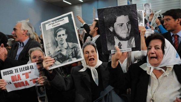 Members of the organization Madres de Plaza Mayo hold photos of the victims disappeared during Argentina's bloody dictatorship.