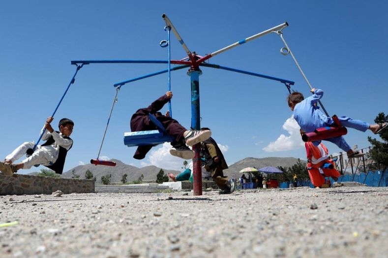 Children ride a carousel during the first day of the Muslim holiday of Eid al-Fit in Kabul, Afghanistan. 