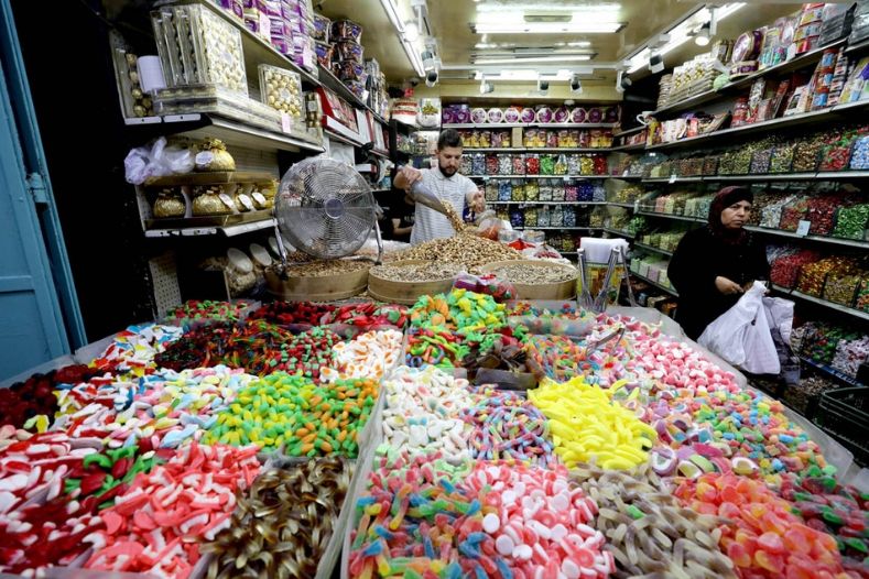 Palestinians shop ahead of the Muslim holiday of Eid al-Fitr in Jerusalem's Old City.