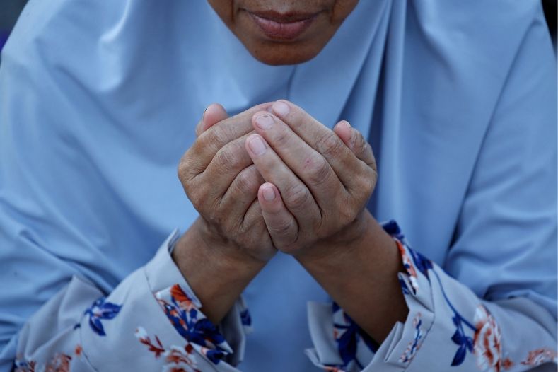 A Muslim woman prays during Eid al-Fitr at Sunda Kelapa port in Jakarta, Indonesia, June 5, 2019.