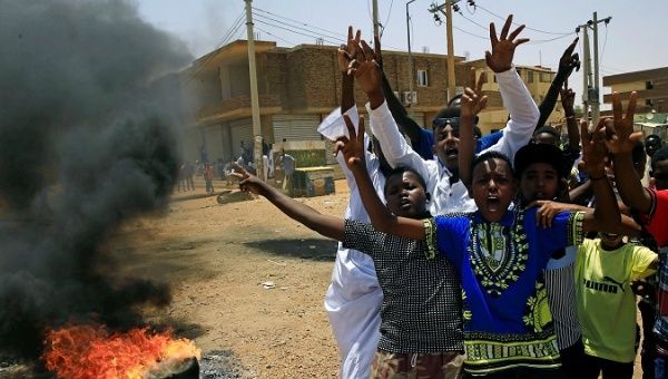 Sudanese protesters gesture and chant slogans at a barricade along a street, demanding that the country's Transitional Military Council hand over power to civilians, in Khartoum, Sudan June 5, 2019.