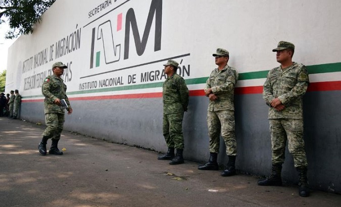 Soldiers assigned to the newly created National Guard keep watch outside the Siglo XXI immigrant detention center as part of the security measures by the federal government, in Tapachula, Mexico.