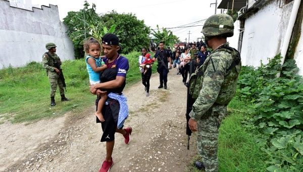 Federal military and police approach a group of migrants in Tenosique, Mexico, June 14, 2019.