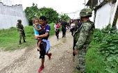 Federal military and police approach a group of migrants in Tenosique, Mexico, June 14, 2019.