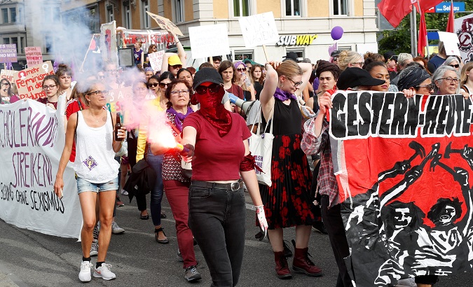 A protester lights during a women's strike in Zurich, Switzerland, June 14, 2019.