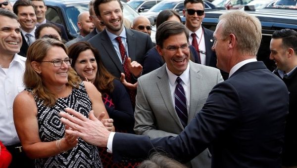 Mark Esper (C) greets outgoing U.S. Acting Defense Secretary Patrick Shanahan (R) in Arlington, Virginia, U.S., June 21, 2019.