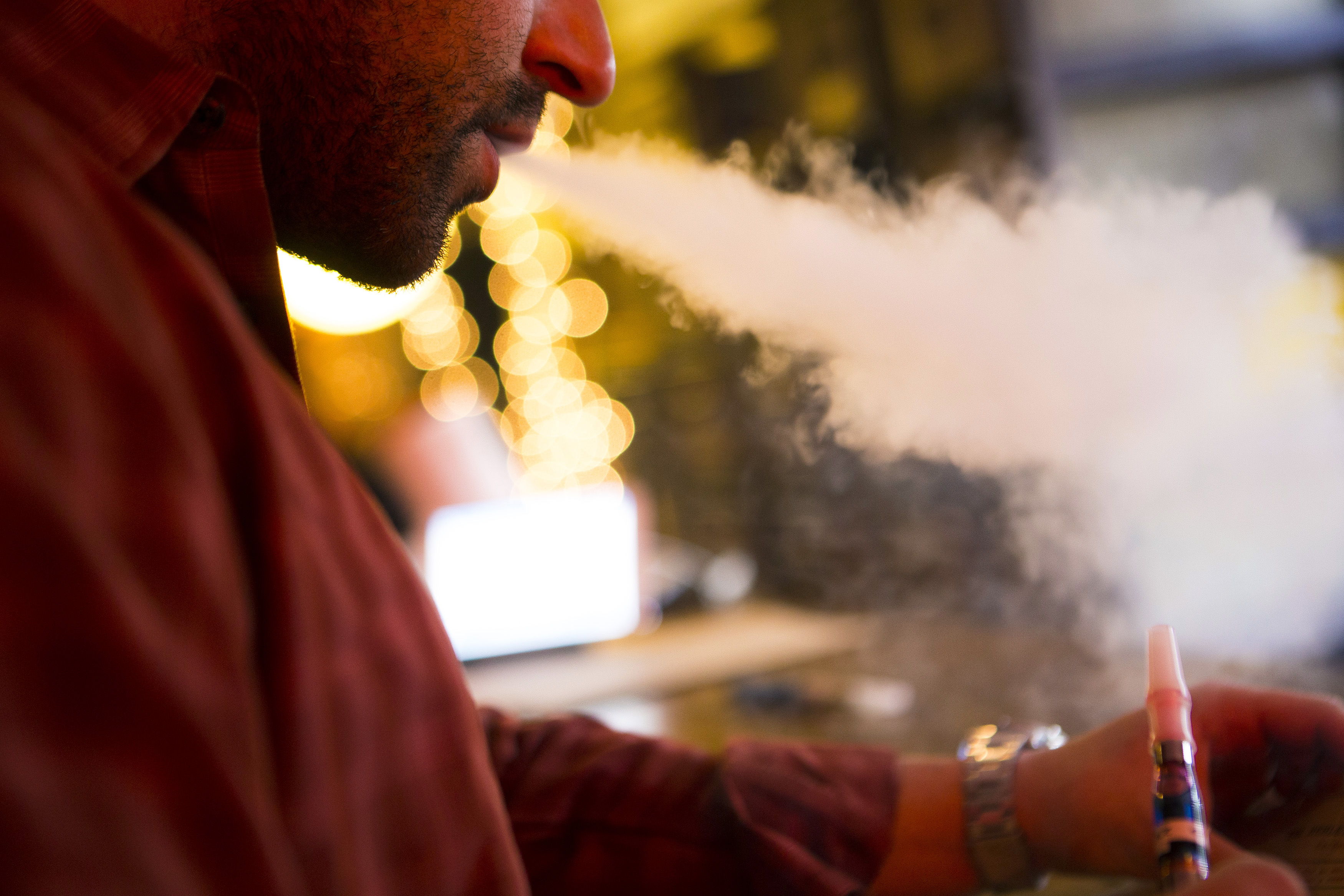 A customer puffs on an e-cigarette at the Henley Vaporium in New York City.