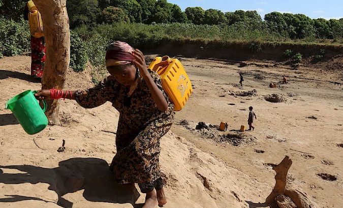 A girl carries a jerry can of water during a drought in Somalia's Shabelle region, Africa is one of region's expected to be hit the hardest.
