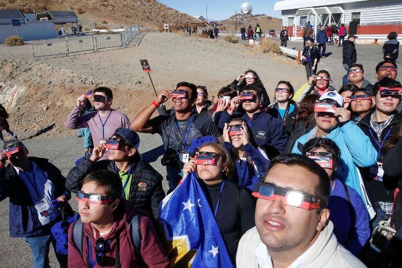 People test their special solar glasses before the solar eclipse in La Silla European Southern Observatory (ESO) at Coquimbo, Chile.