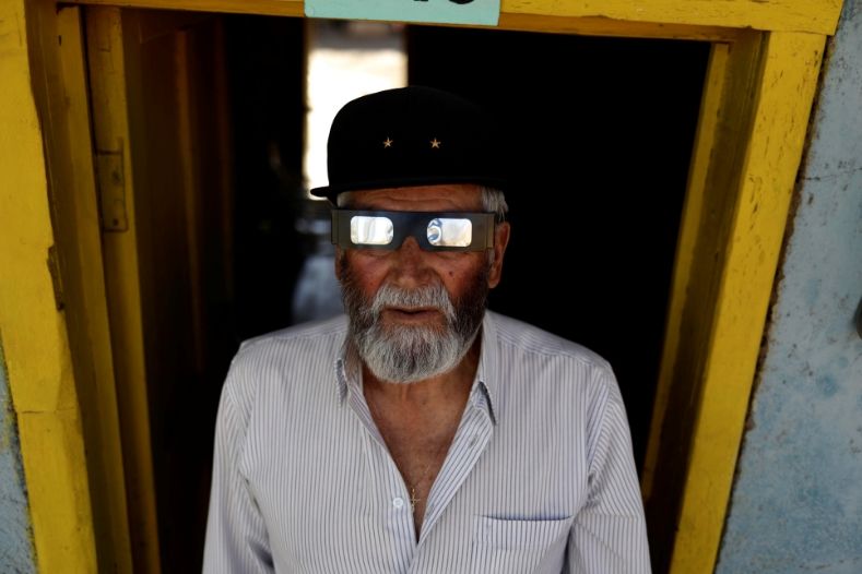 A man tests special glasses for the total solar eclipse in Incahuasi, Chile.