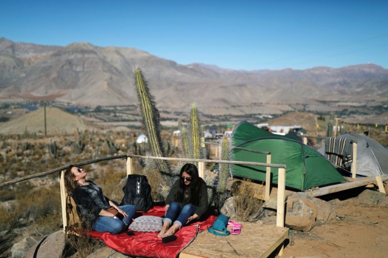 Tourists sit at a campsite at the Mamalluca Observatory, in Valle del Elqui, Chile.