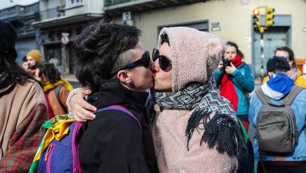 Two women protest by kissing in front of the Argentine Embassy in Montevideo, Uruguay, July 3, 2019.