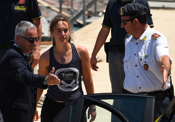 Carola Rackete, 31-year-old Sea-Watch 3 captain, disembarks from a Finance Police boat and is escorted to a car, in Porto Empedocle, Italy, July 1, 2019.