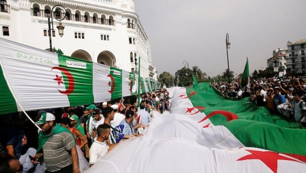 Demonstrators carry flags during a protest demanding the removal of the ruling elite in Algiers, Algeria July 5, 2019, the day marking the country's independence day.