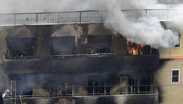 Smoke and flame rise from the three-story Kyoto Animation building which was torched in Kyoto