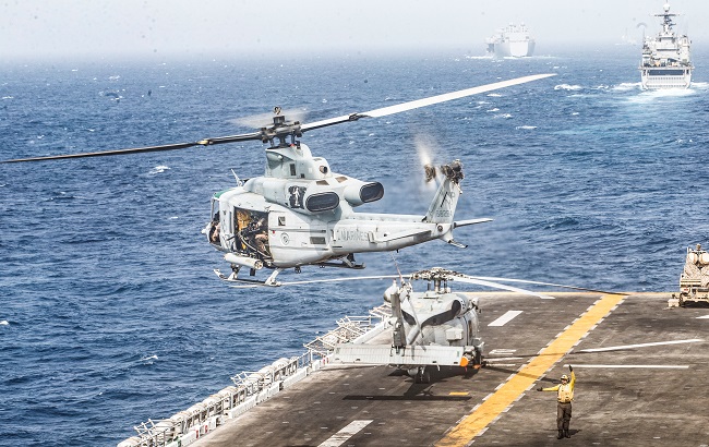 A UH-1Y Venom helicopter with Marine Medium Tiltrotor Squadron (VMM) 163 (Reinforced), 11th Marine Expeditionary Unit (MEU), takes off from the flight deck of the amphibious assault ship USS Boxer (LHD 4) during its transit through Strait of Hormuz
