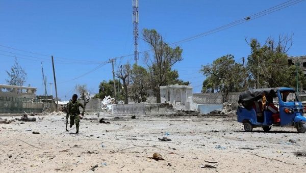 A Somali soldier runs to hold position as al-Shabaab militia storms a government building in Mogadishu, Somalia March 23, 2019.