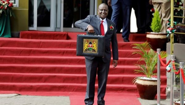  Kenya's Cabinet Secretary of National Treasury (Finance Minister) Henry Rotich holds up a briefcase containing the Government Budget for the 2019/20 fiscal year in Nairobi, Kenya, June 13, 2019.