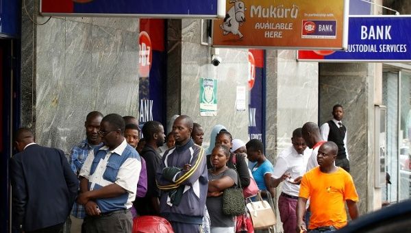 Zimbabweans queue outside a bank in Harare, Zimbabwe, February 26, 2019.