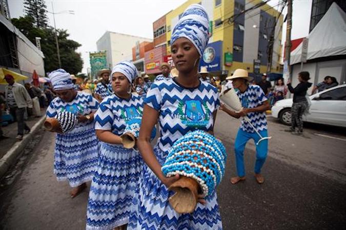 Members of Maracatu Nacao Raizes de Pai performing in the streets of Garanhuns on July 21, 2019.