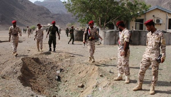 Soldiers are seen at the scene of the blast after a missile attack on a military parade during a graduation ceremony for newly recruited troopers in Aden