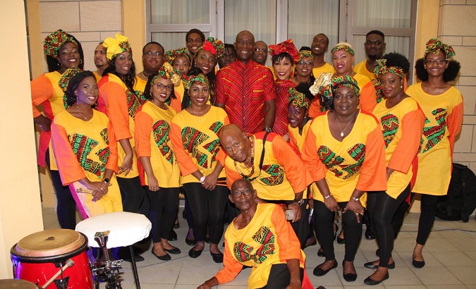 Trinidad and Tobago's Prime Minister Dr. Keith Rowley and his wife, Sharon, take a picture with members of the Shell Invaders Steel Orchestra during an Emancipation Day Celebration Saturday.