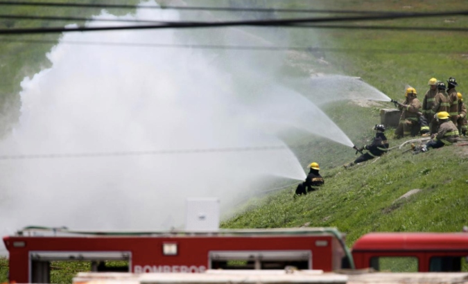 Firefighters hose down near the area where a gas leak caused an evacuation in Nextlalpan municipality, in Mexico state, Mexico August 2, 2019.