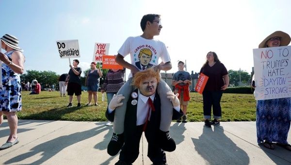 Protestors gather around a baby Trump balloon to voice their rally against gun violence and a visit from U.S. President Donald Trump following a mass shooting in Dayton, Ohio, U.S. August 7, 2019.