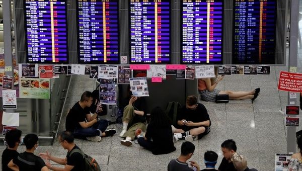 Passengers and demonstrators rest in the arrival hall after flights were cancelled due to the anti-extradition bill protest at Hong Kong Airport, China Aug. 12, 2019. 