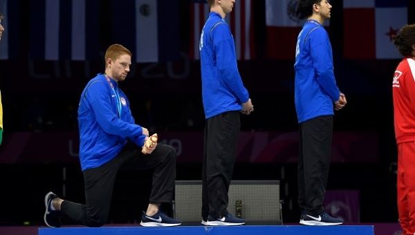 Race Imboden takes knee during the Men's Foil Team medal ceremony in Fencing at the Pan American Games Lima 2019.