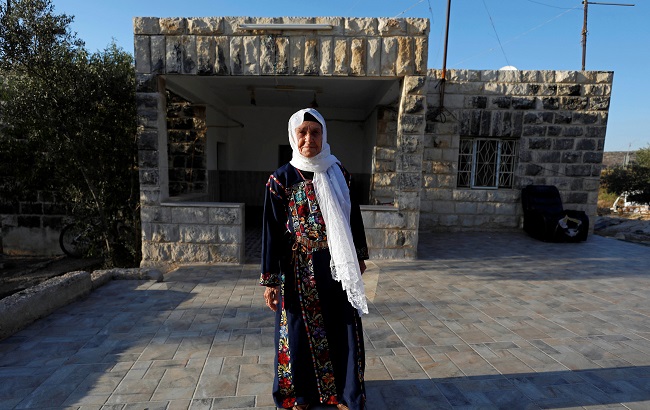 Muftia, the grandmother of U.S. congresswoman Rashida Tlaib, poses for a photo in front of her house in the village of Beit Ur Al-Fauqa in the Israeli-occupied West Bank August 16, 2019. Picture taken August 16, 2019.