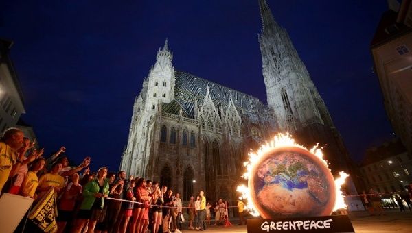 Human rights defenders and environment activists protest against Amazon deforestation at St. Stephen's Cathedral in Vienna, Austria, August 26, 2019. 