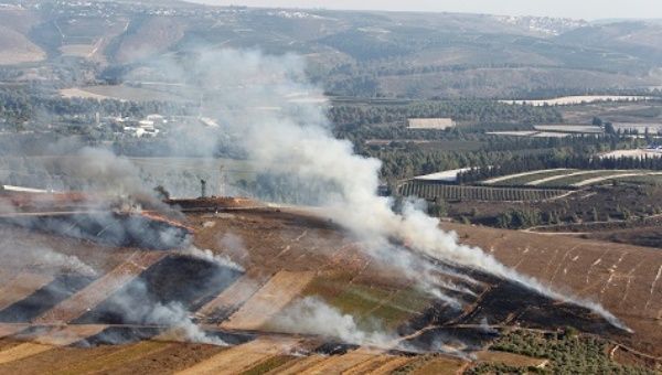 Smoke rises from shells fired from Israel in Maroun Al-Ras village, near the border with Israel, in southern Lebanon.