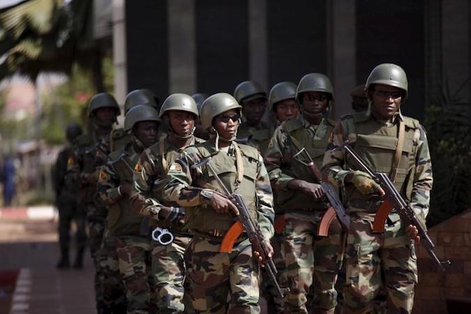 Soldiers patrol before the arrival of Mali's President Ibrahim Boubacar Keita outside the Radisson hotel in Bamako, Mali, November 21, 2015 following an attack by Islamist militants.