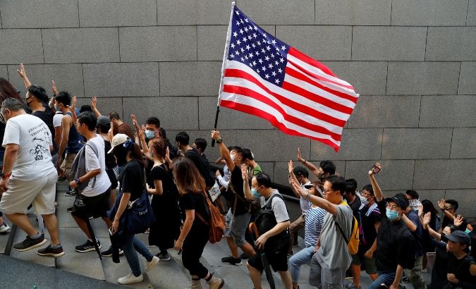Protesters hold up five fingers and a U.S. flag during a rally to the U.S. Consulate General in Hong Kong, China September 8, 2019.