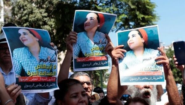 Moroccan activists hold the poster of Hajar Raissouni, a journalist charged with fornication and abortion, during a protest outside the Rabat tribunal, Morocco September 9, 2019. 