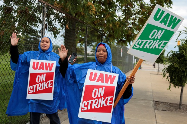 United Auto Workers, Aramark workers, carry strike signs outside the General Motors Detroit-Hamtramck assembly plant in Detroit, Michigan, U.S. September 15, 2019.